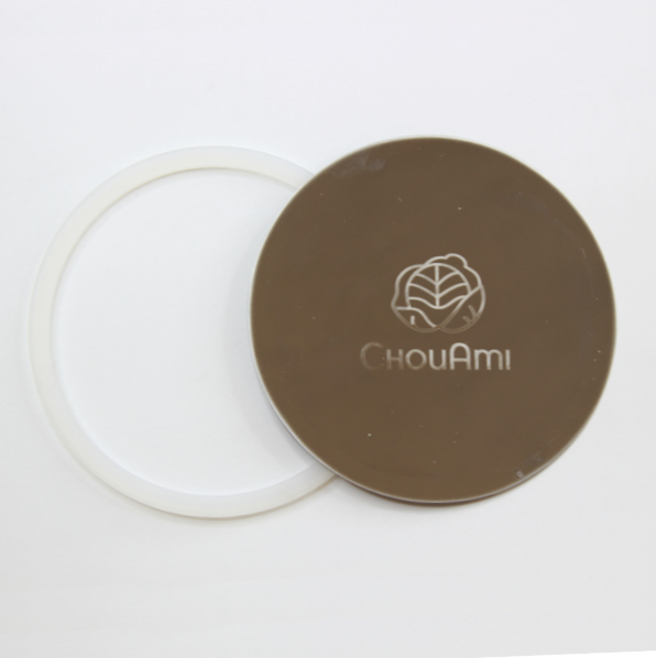 ChouAmi stainless steel flat panel with white silicone gasket ring beside it, top-down on white.