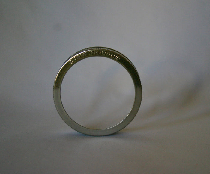 ChouAmi stainless steel ring with 'le petit fermenteur' embossing, side profile view on white.