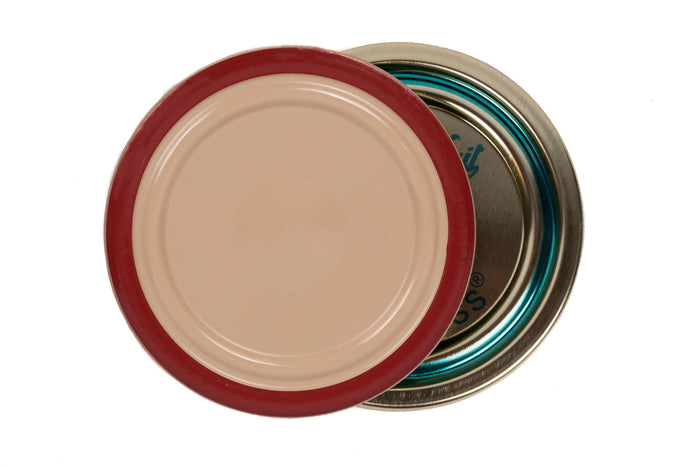 Le Parfait Familia Wiss sealing cap top and bottom views - tan top with red border and gold underside with teal 'pierce-here' indicator.