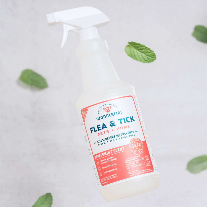 Wondercide Peppermint Flea & Tick Spray for Pets + Home, shown among mint leaves, features natural ingredients and is effective against pests. The label notes it's safe for dogs and cats.