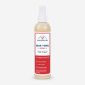 A bottle of Wondercide Skin Tonic Itch Spray for Dogs + Cats features a red and white label, promoting Natural Relief for Itch + Allergy with neem oil. It acts quickly, enhances skin health, and cautions to keep out of reach of children.