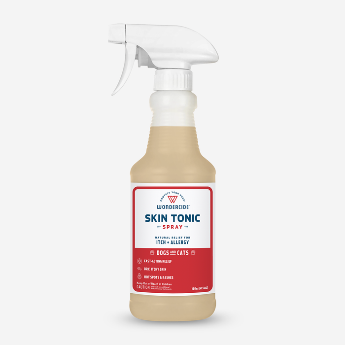 Wondercides Skin Tonic Itch Spray for Dogs + Cats with Natural Essential Oils provides soothing relief for pets itch and allergy issues using natural ingredients like neem oil. The bottle is clear with a red label and a white spray nozzle.