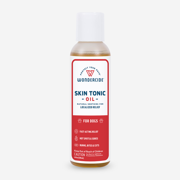 Wondercide Skin Tonic Topical Oil for Dogs, with a red and white label, contains neem oil for natural relief of burns, bites, cuts, hot spots, and sores.