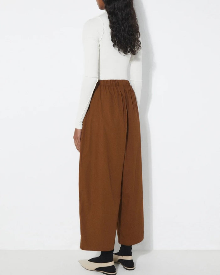 Tobacco brown Turin Pants from Rita Row at Clad, a sustainable clothing store in Asheville, NC. Paired with black socks and beige slingback flats.